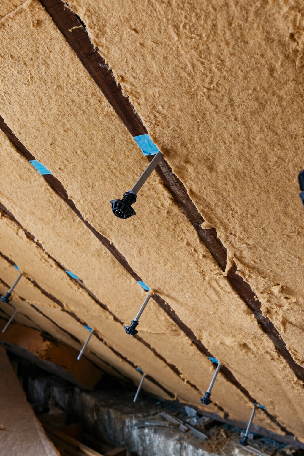 Roof slope fully insulated with wood fibre between the battens, fixings ready for the second layer
