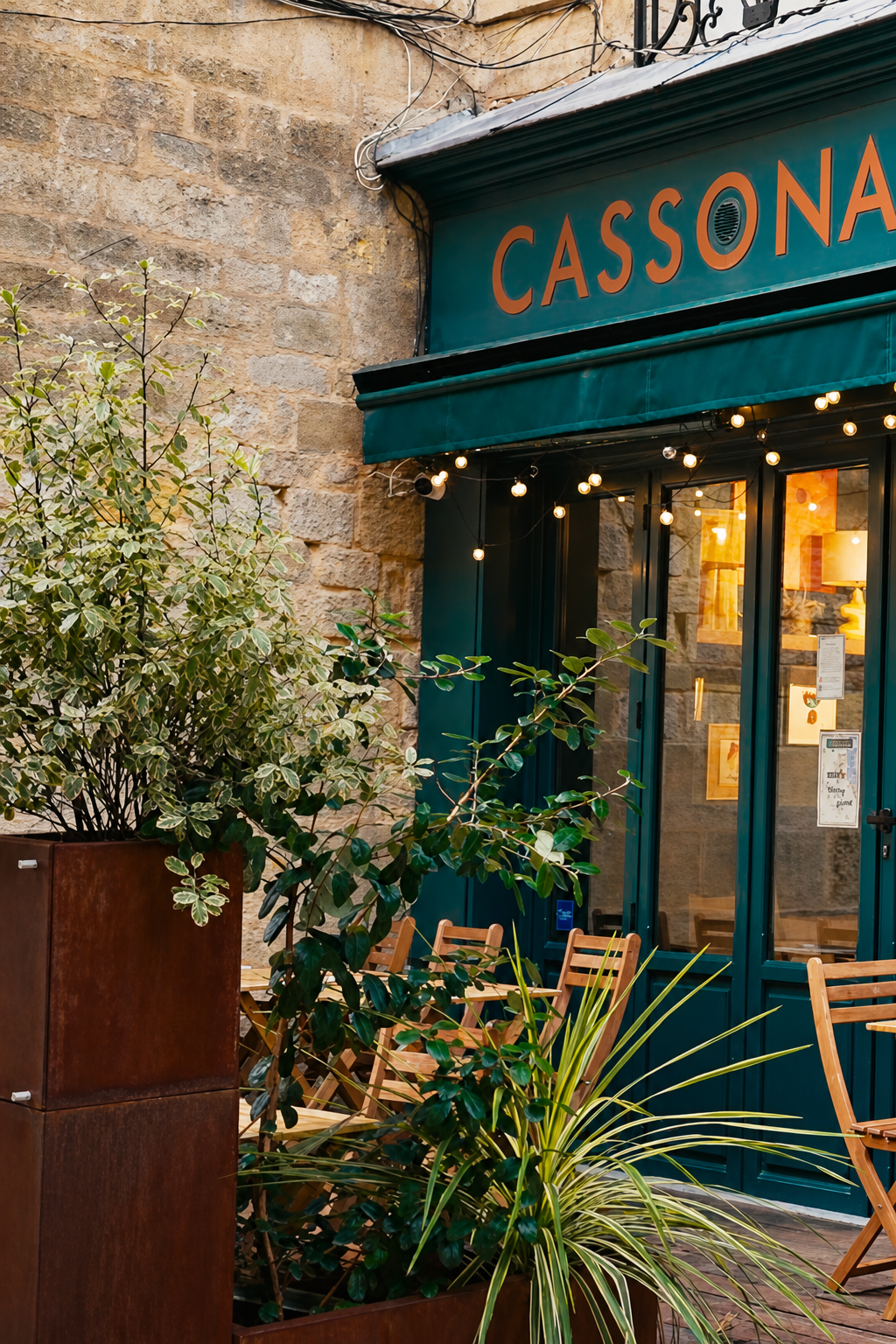 The teal shopfront of Cassonade with canelés in the window